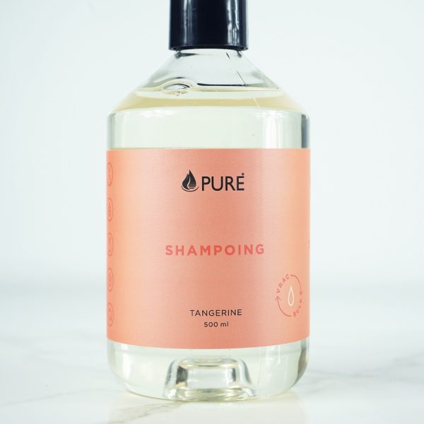 Pure brand organic and biodegradable shampoo in a clear bottle with orange label.